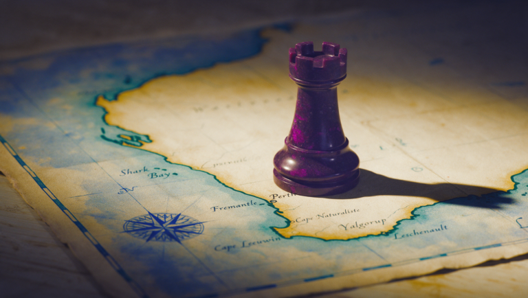 Purple chess rook standing on an old map